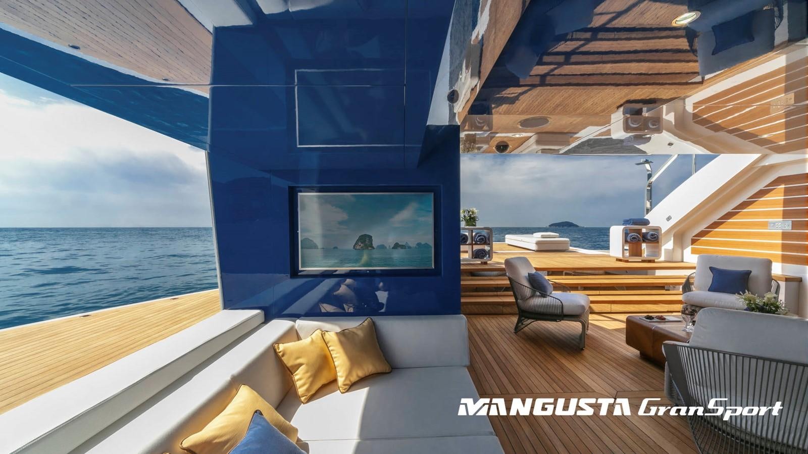 a room with a couch and a tv on the wall aboard MANGUSTA 165REV/04 Yacht for Sale