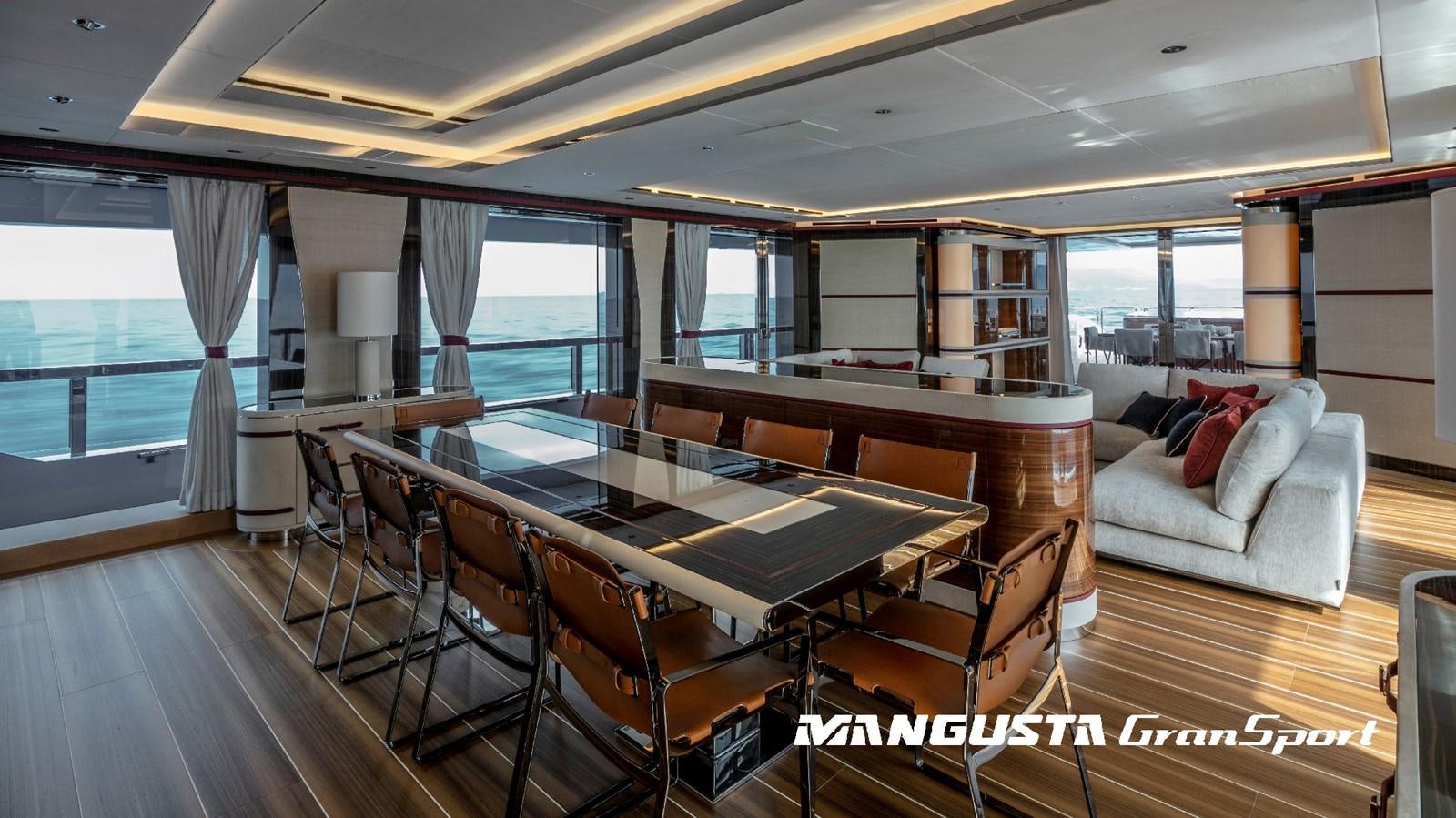a room with a table chairs and a couch aboard MANGUSTA 165REV/04 Yacht for Sale