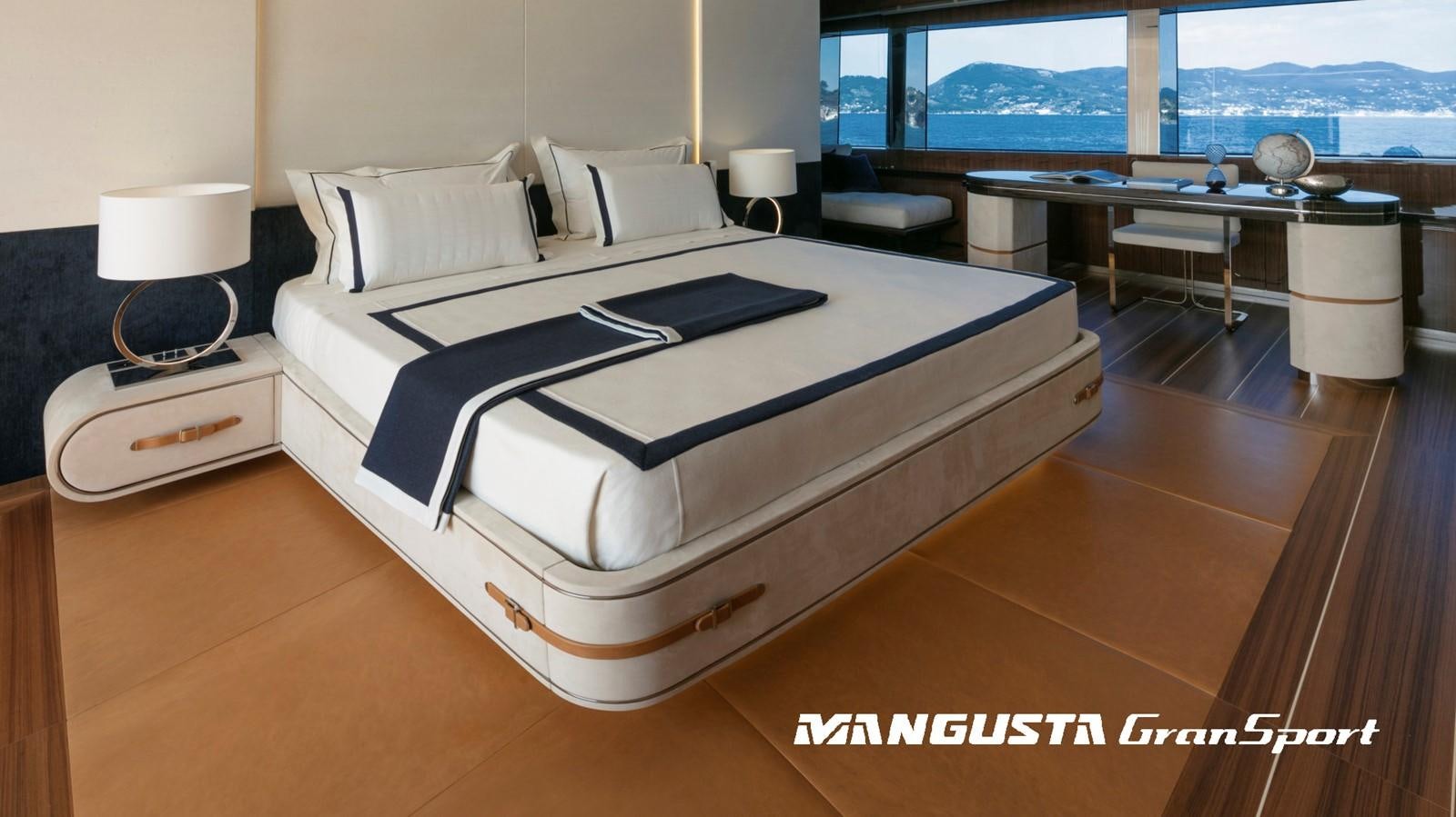 a bed with a black and white bed spread aboard MANGUSTA 165REV/04 Yacht for Sale
