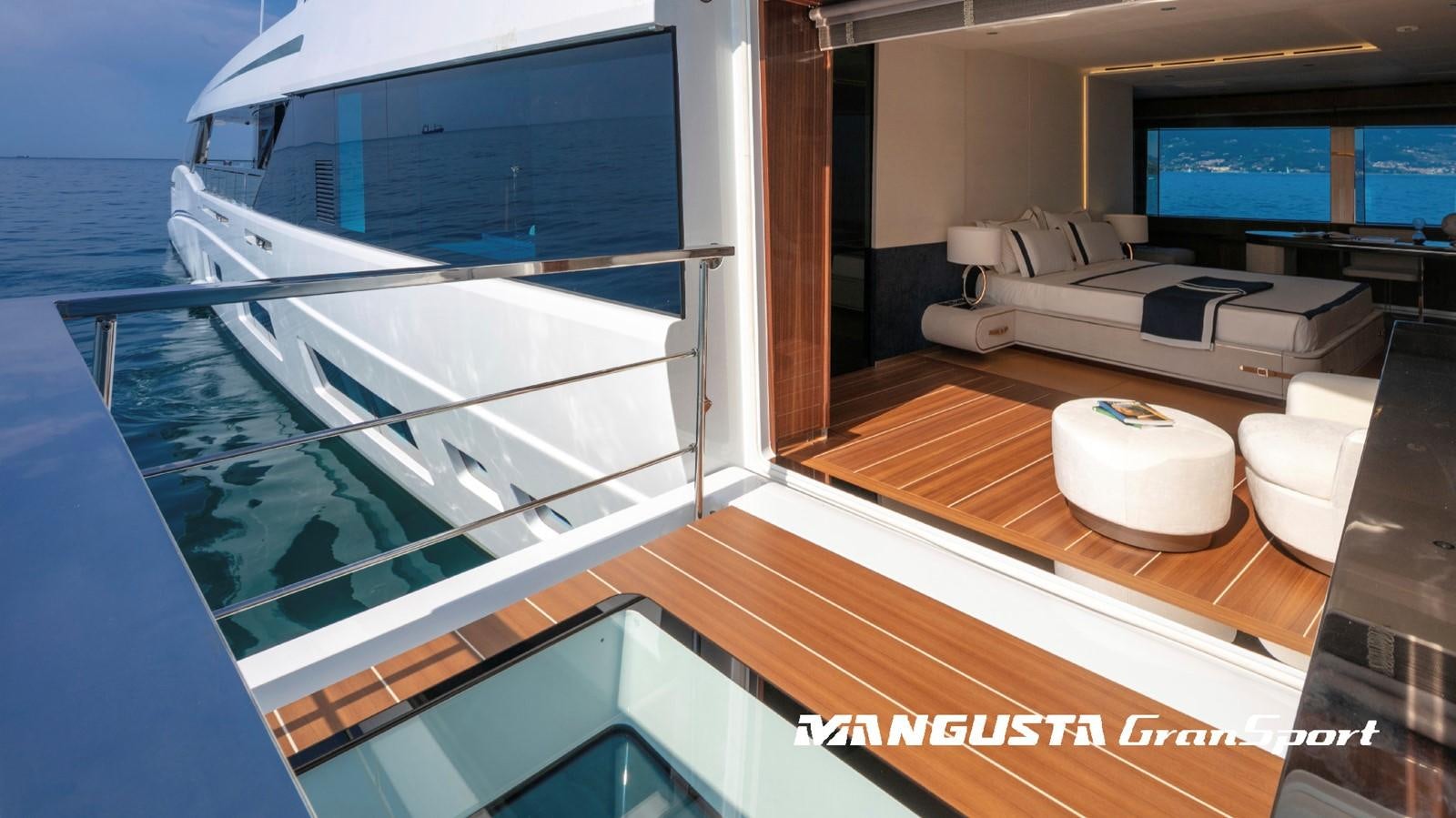 a room with a bed and a large window aboard MANGUSTA 165REV/04 Yacht for Sale