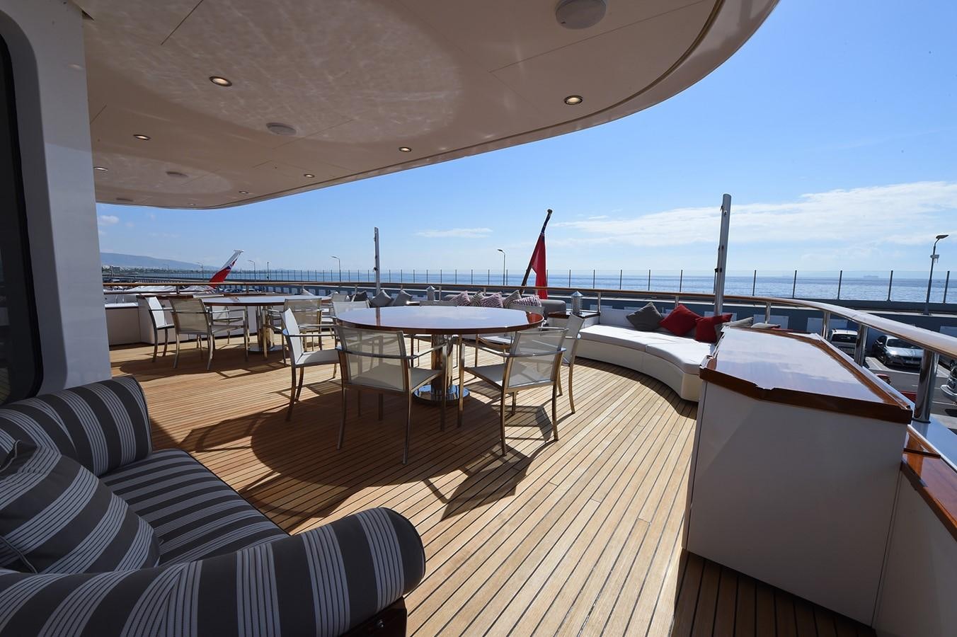 a deck with a table and chairs on it aboard AMORE MIO 2 Yacht for Sale