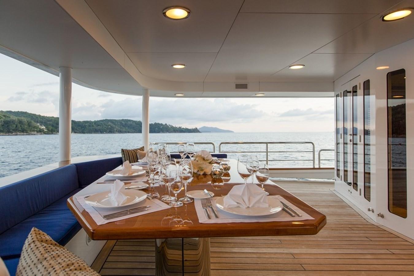 a table with plates and glasses on it aboard NORTHERN SUN Yacht for Sale