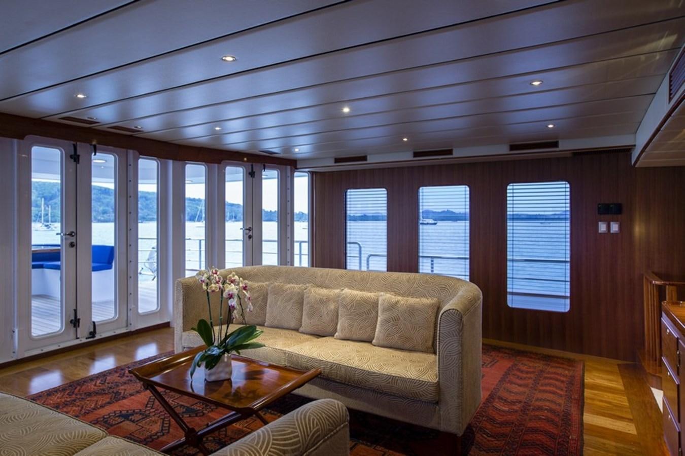 a living room with a couch and a table aboard NORTHERN SUN Yacht for Sale