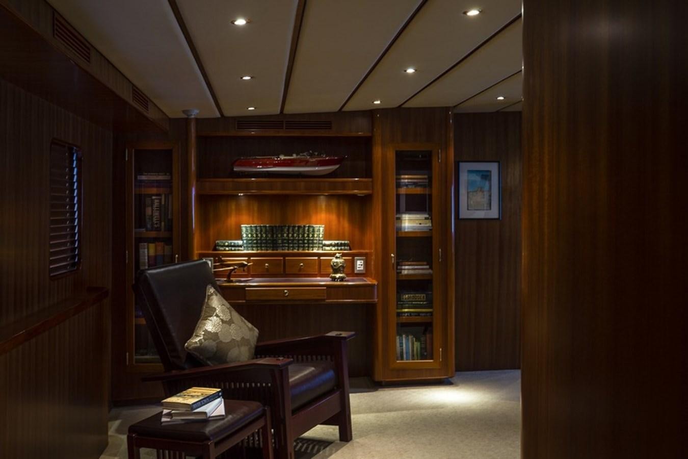 a room with a couch and a book shelf aboard NORTHERN SUN Yacht for Sale