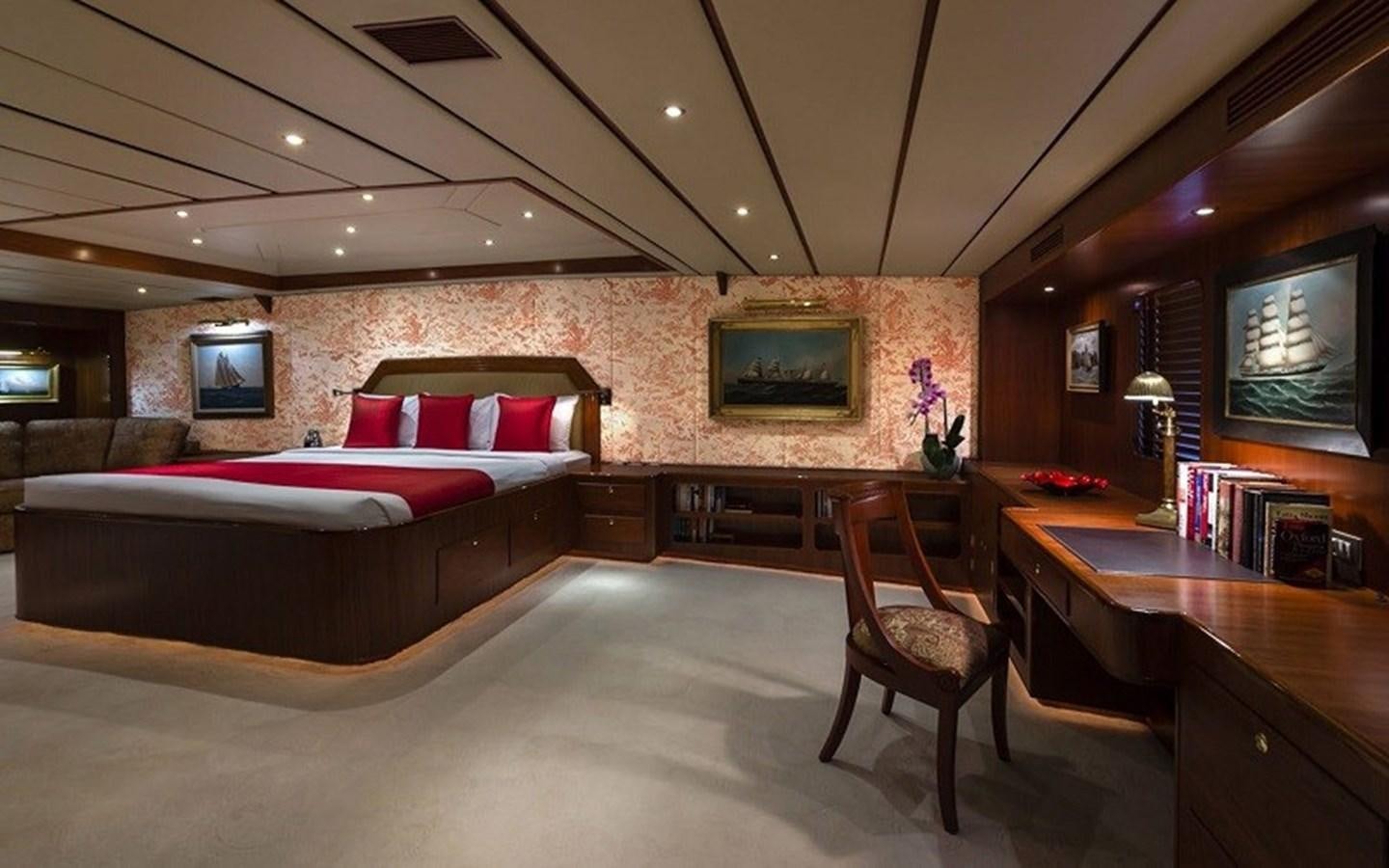 a room with a bed and a desk aboard NORTHERN SUN Yacht for Sale