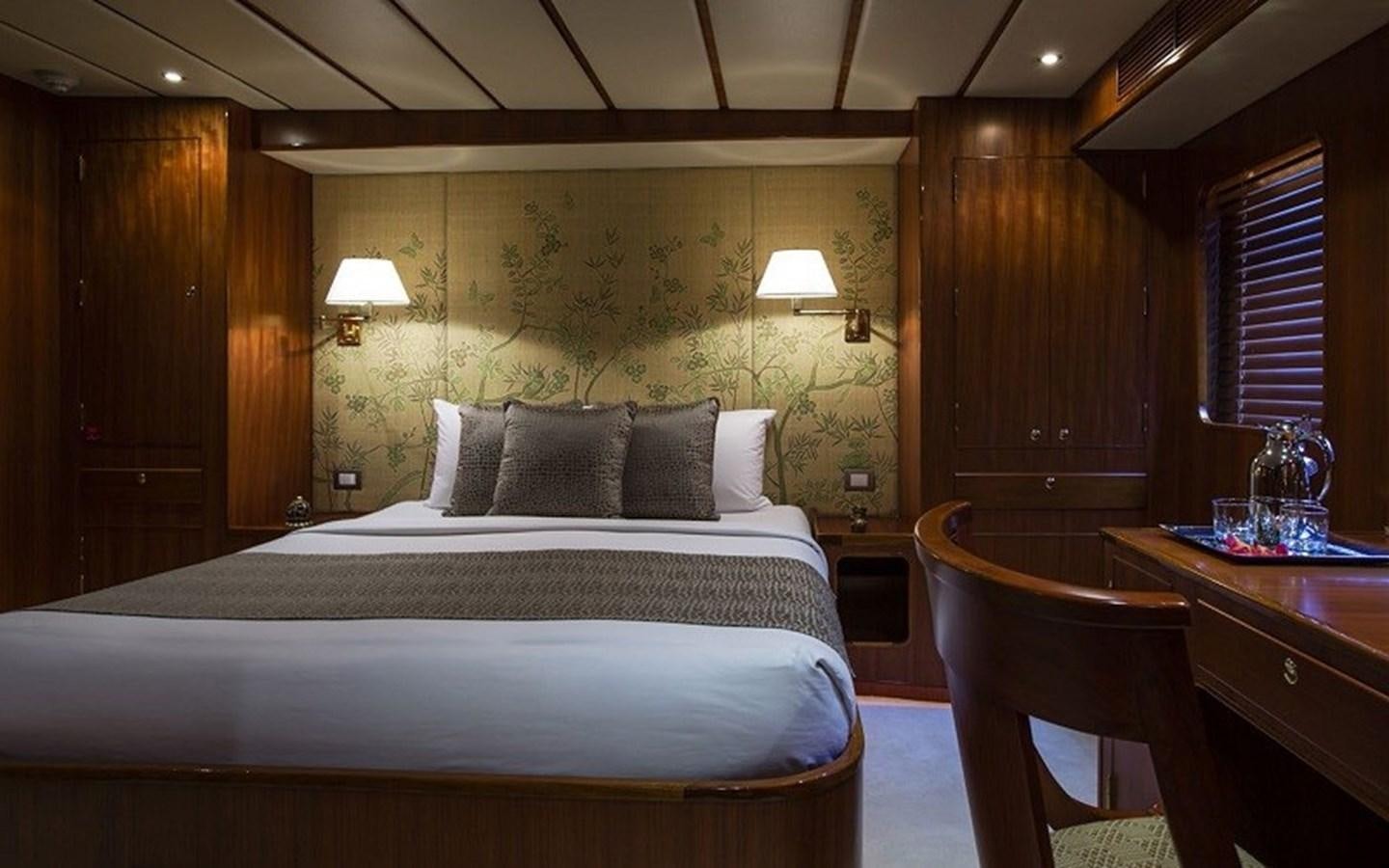 a bed with a white bed spread aboard NORTHERN SUN Yacht for Sale