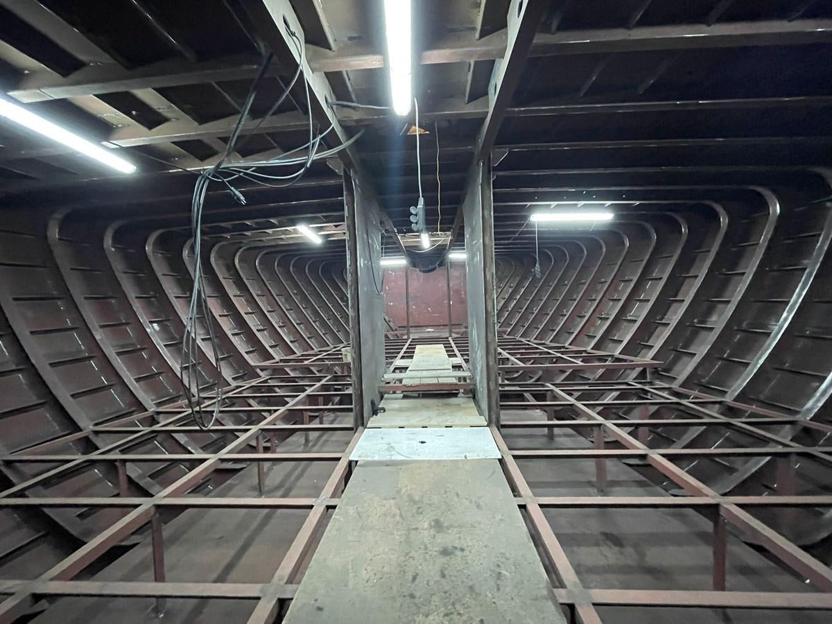 a large room with many metal pipes aboard MITI K Yacht for Sale