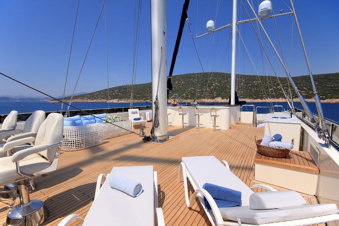 a deck with a laptop and chairs aboard MEIRA Yacht for Sale