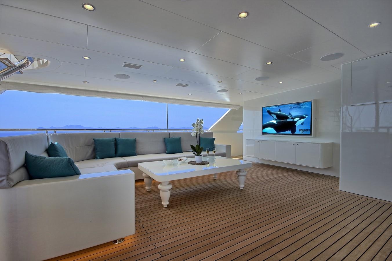 a living room with a large screen aboard MEIRA Yacht for Sale