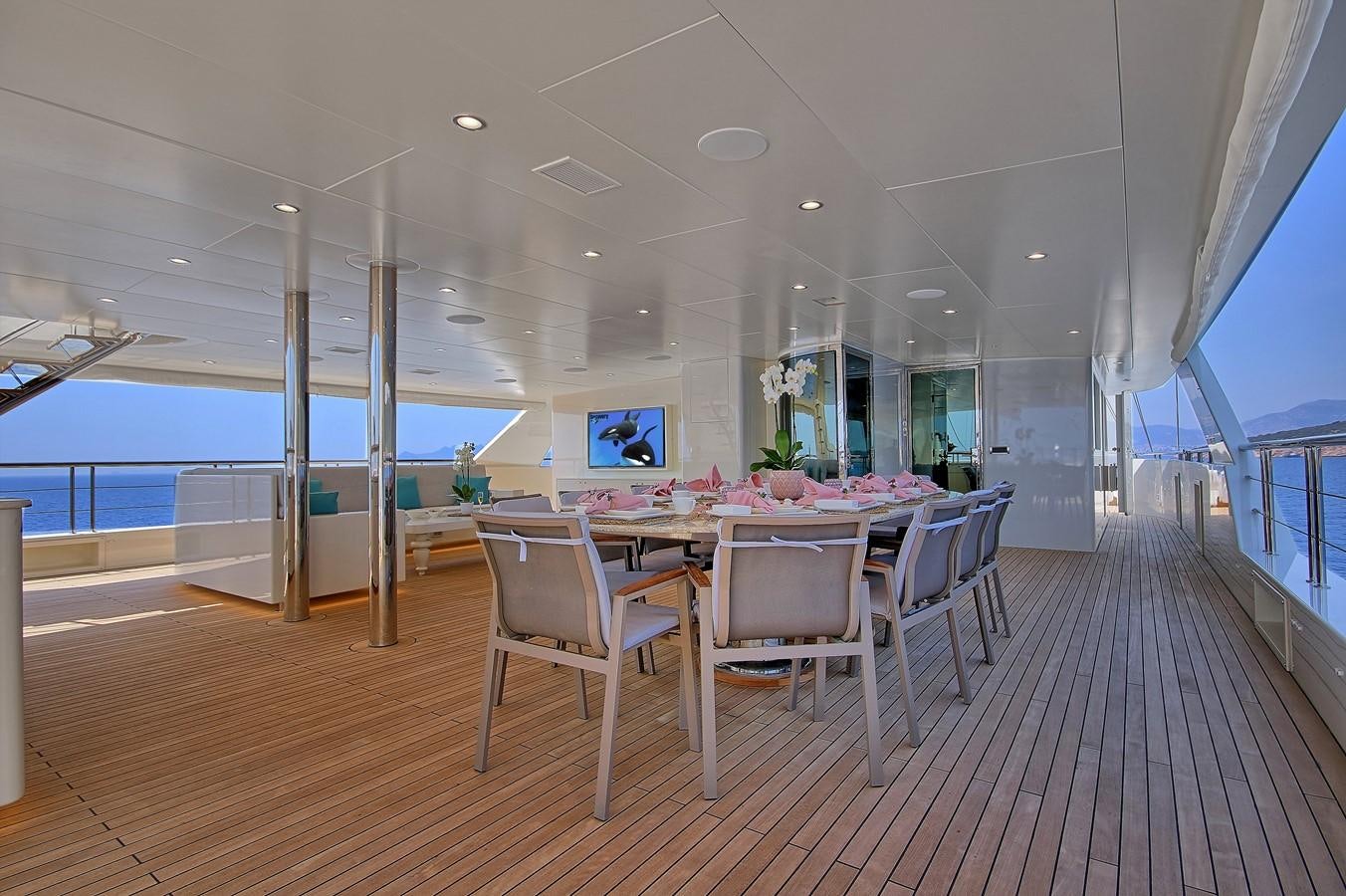 a room with tables and chairs aboard MEIRA Yacht for Sale