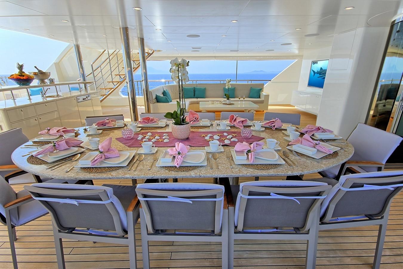 a table set with plates and napkins aboard MEIRA Yacht for Sale