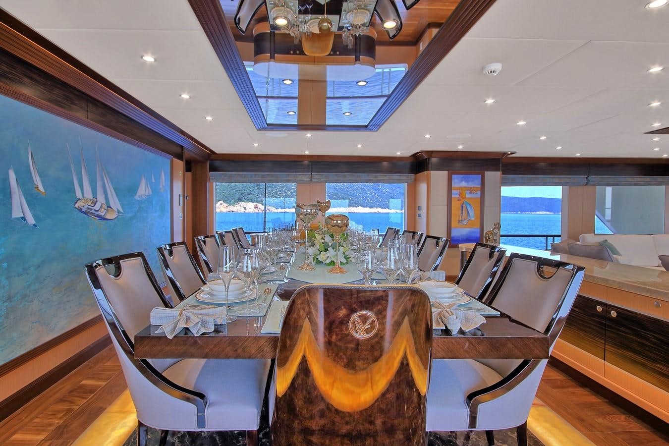 a dining room with a table set aboard MEIRA Yacht for Sale