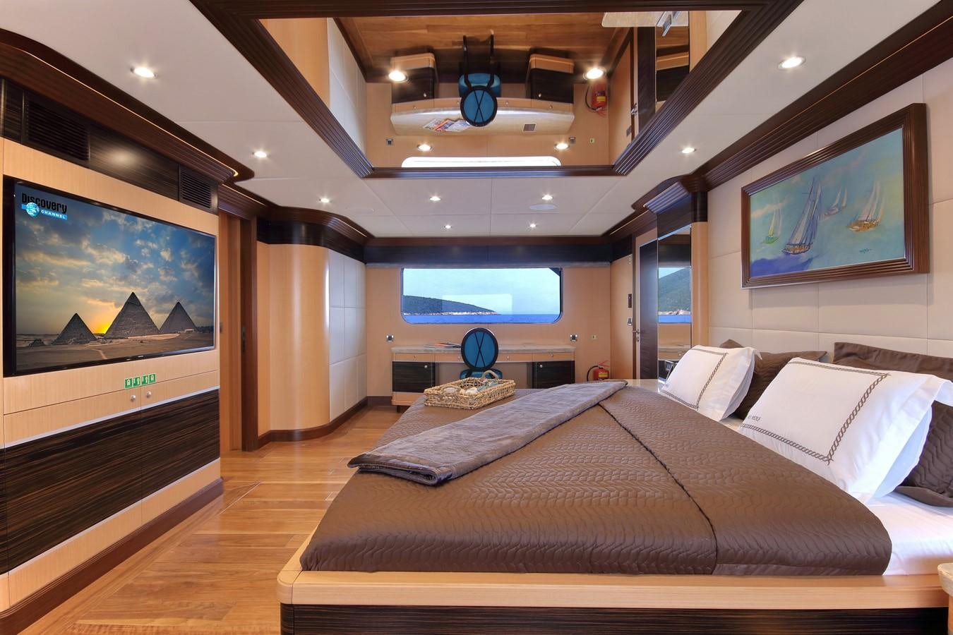 a large bed in a room aboard MEIRA Yacht for Sale