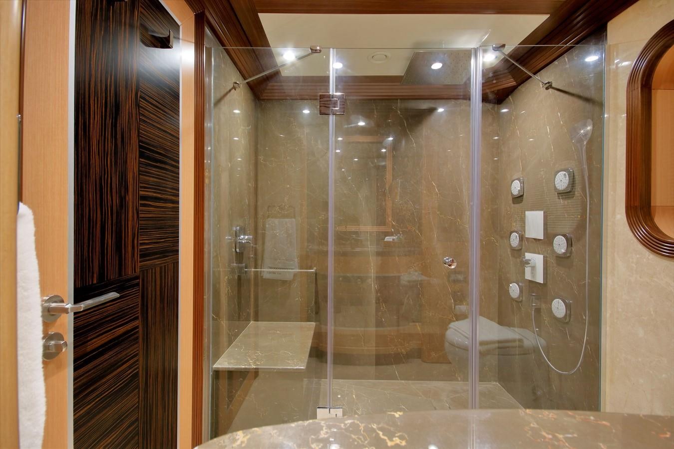 a bathroom with a glass shower aboard MEIRA Yacht for Sale