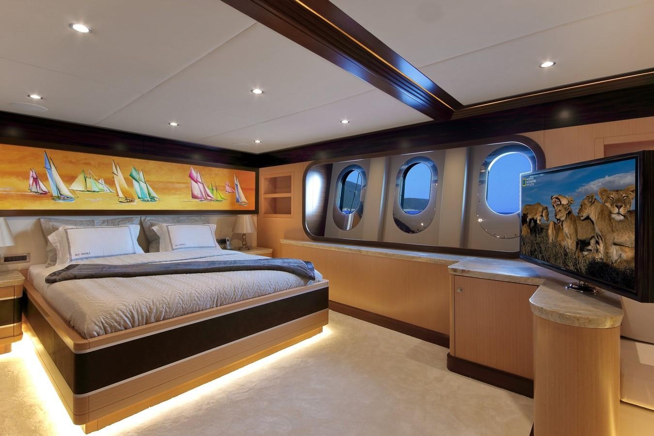 a room with a bed and a mirror aboard MEIRA Yacht for Sale