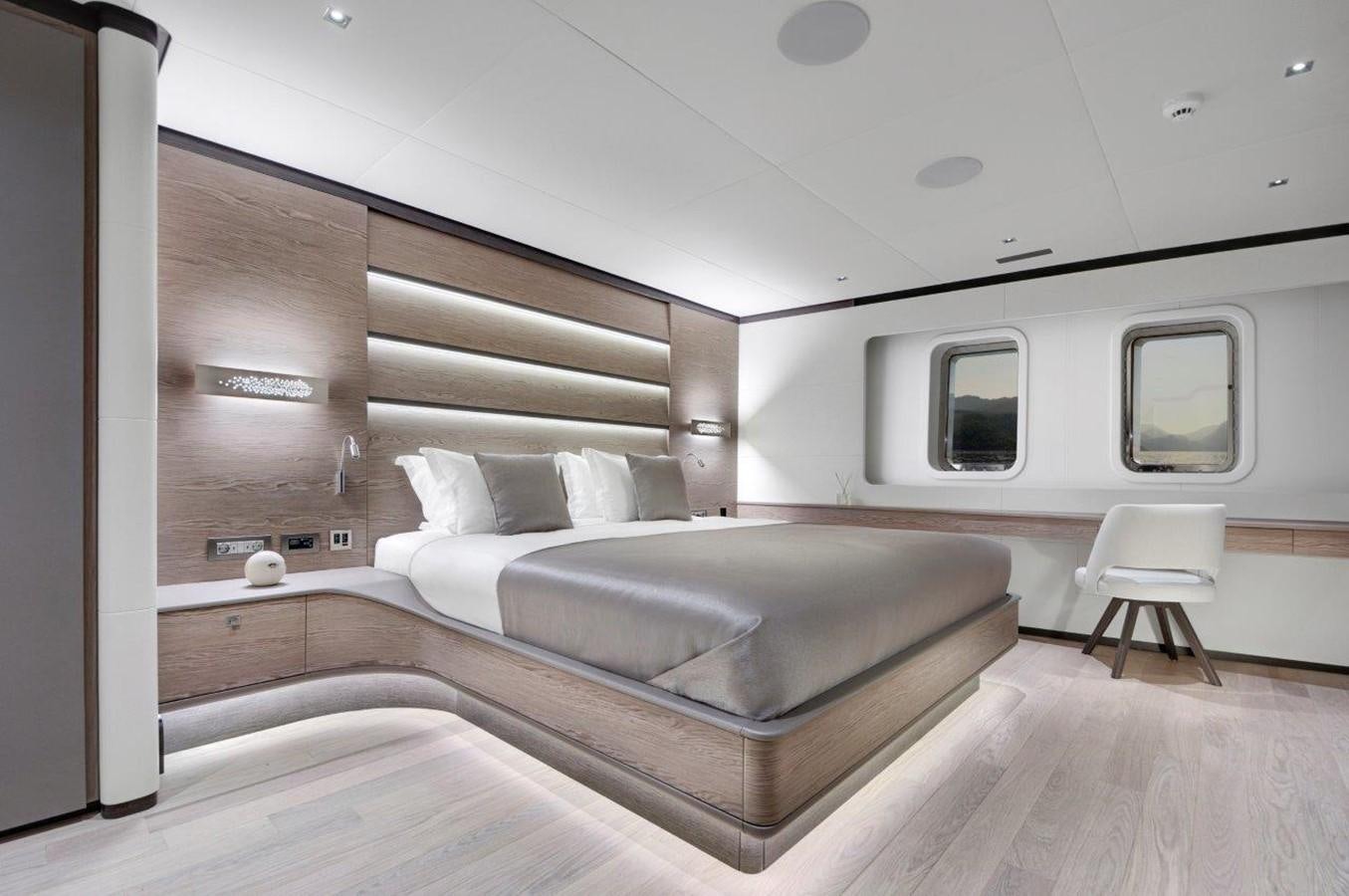a bedroom with a bed and a chair aboard ALL ABOUT U 2 Yacht for Sale