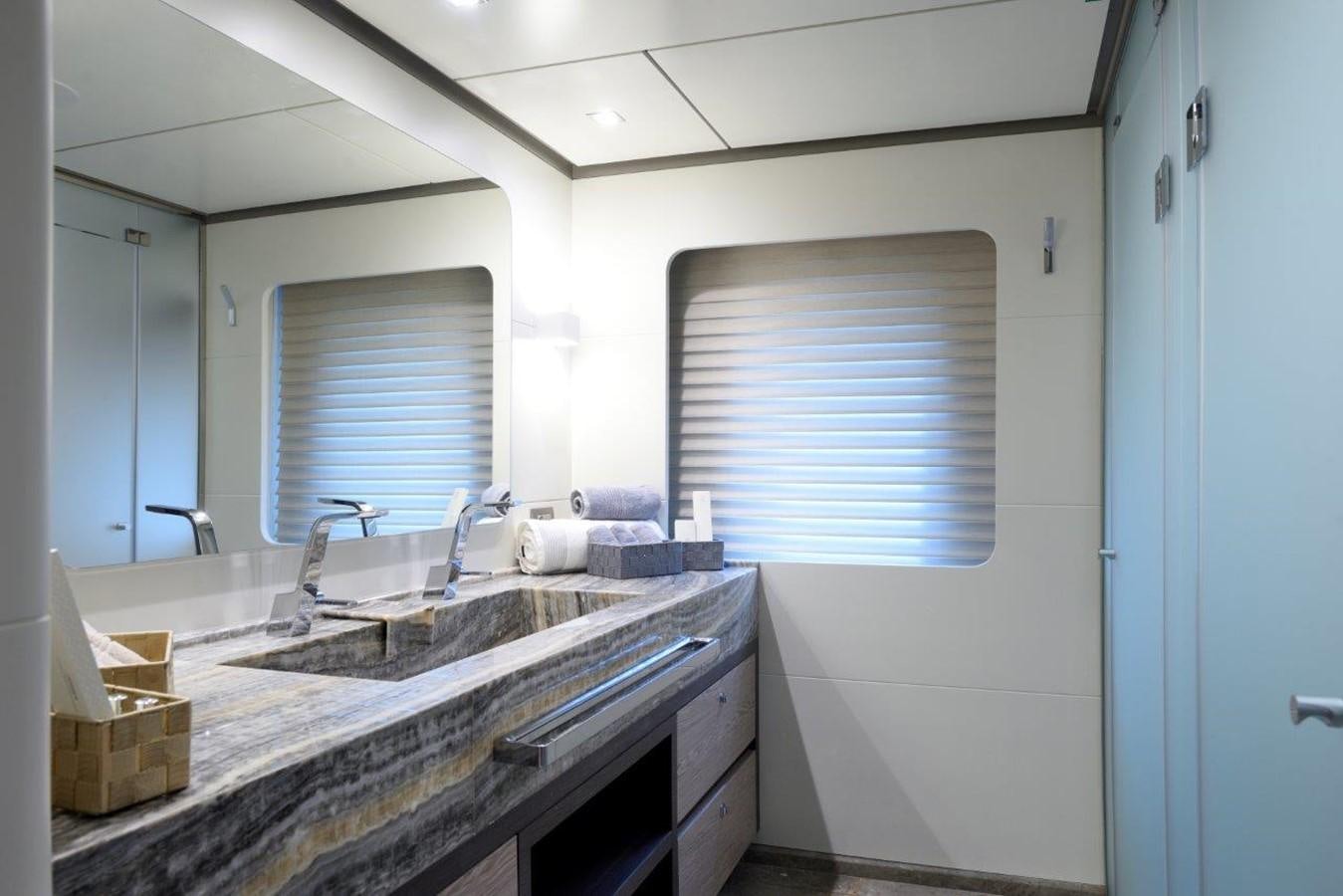 a bathroom with a sink and a mirror aboard ALL ABOUT U 2 Yacht for Sale