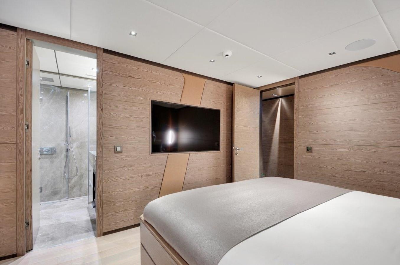 a room with a bed and a television aboard ALL ABOUT U 2 Yacht for Sale