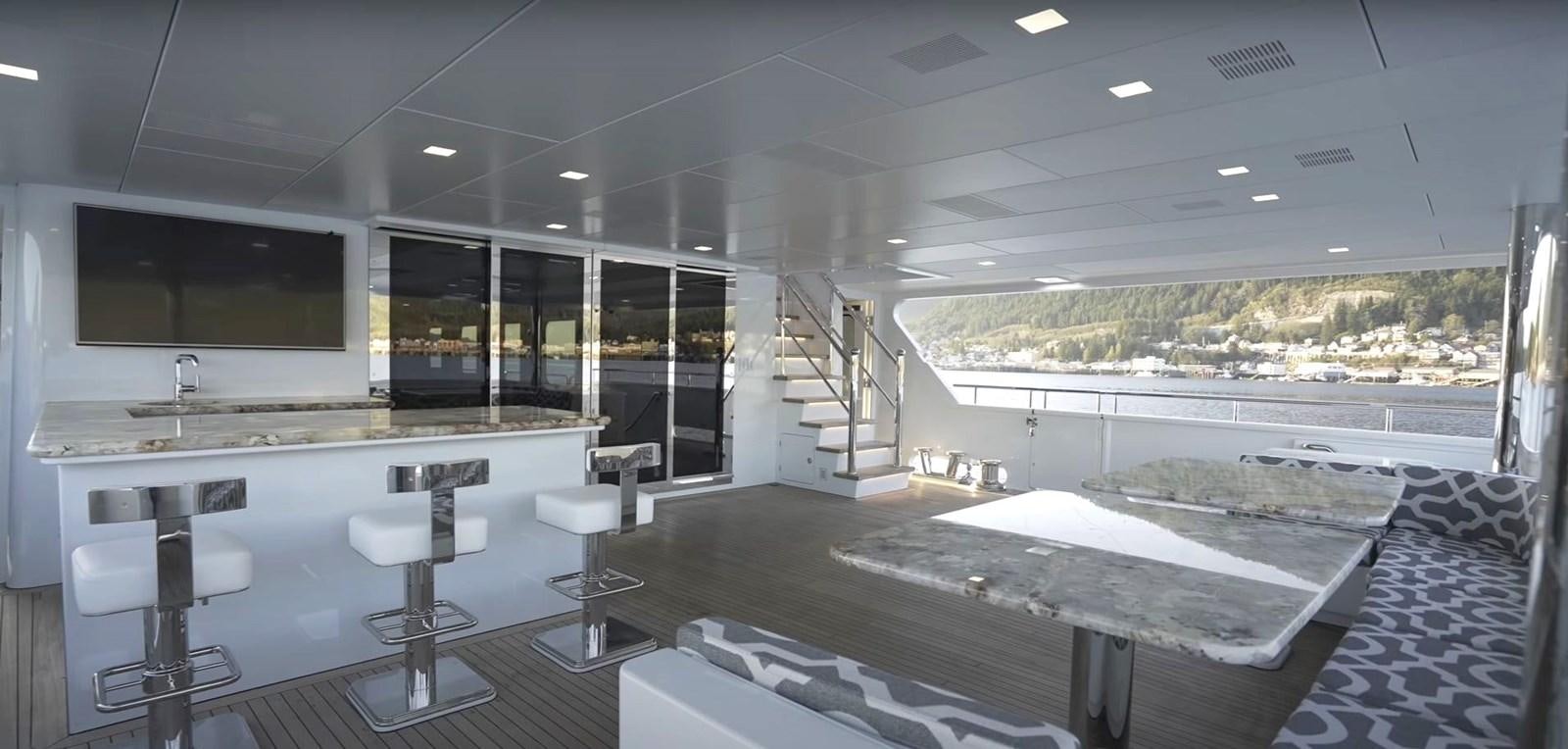 a room with a large table and chairs and a tv aboard JACKPOT Yacht for Sale