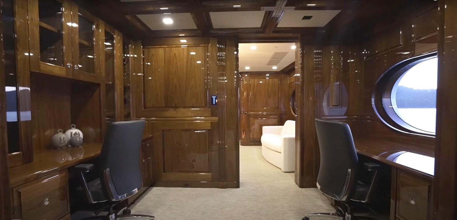 a room with a desk and chairs aboard JACKPOT Yacht for Sale