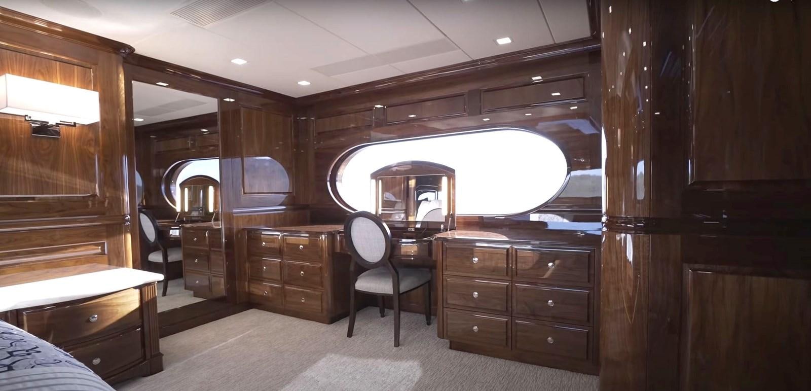 a room with a bed and a desk aboard JACKPOT Yacht for Sale