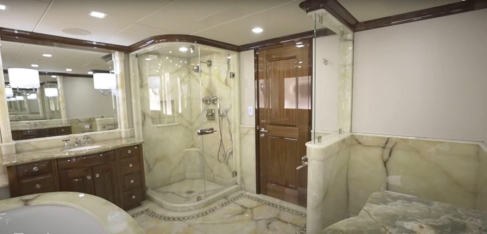 a bathroom with a glass shower aboard JACKPOT Yacht for Sale