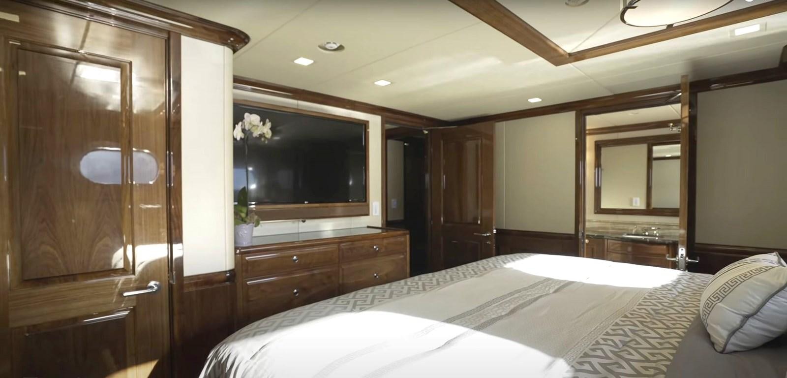 a bedroom with a bed and a closet aboard JACKPOT Yacht for Sale