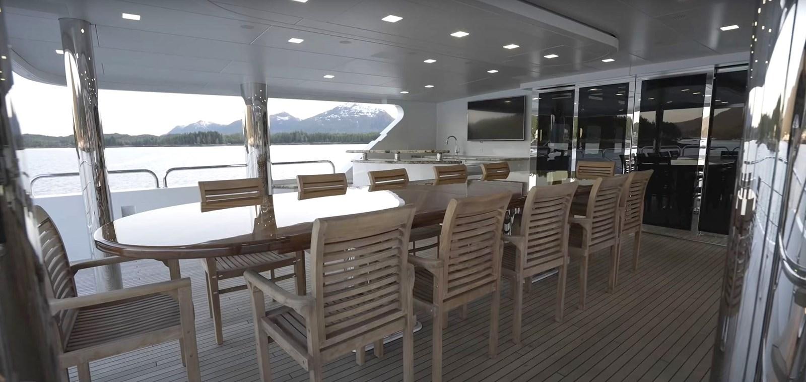 a room with a table and chairs aboard JACKPOT Yacht for Sale