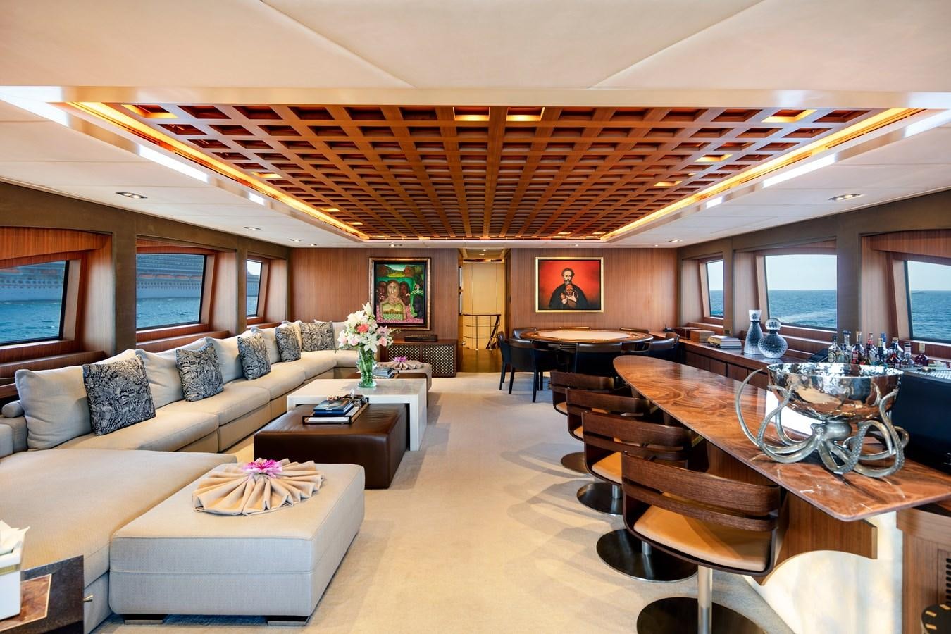 a living room with a piano and a piano aboard CHAMPAGNE SEAS Yacht for Charter