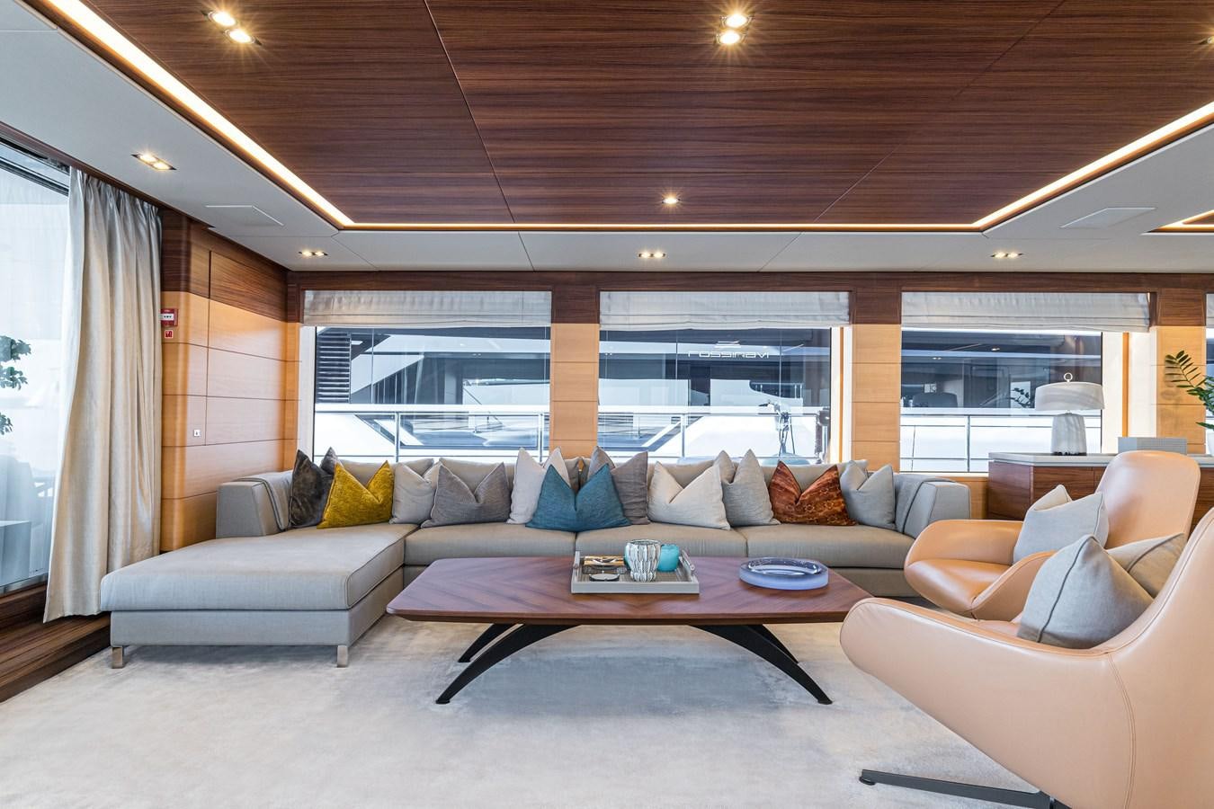 a living room with a large window aboard TRIUMPH Yacht for Charter
