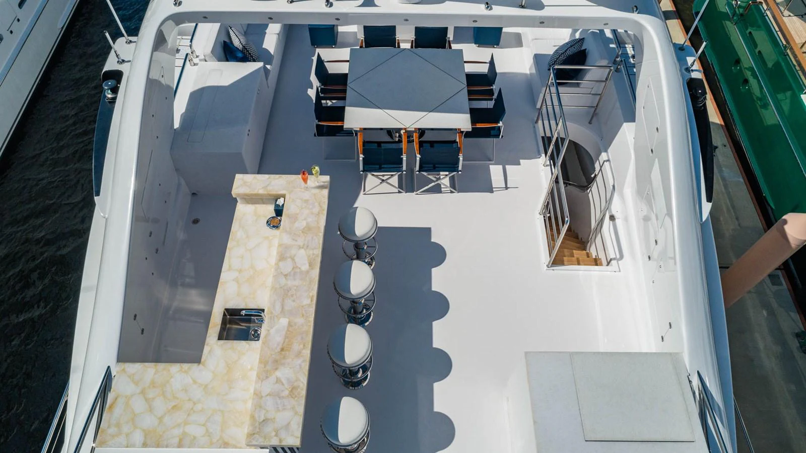 a large white boat with a deck and chairs on it aboard APRICITY Yacht for Sale