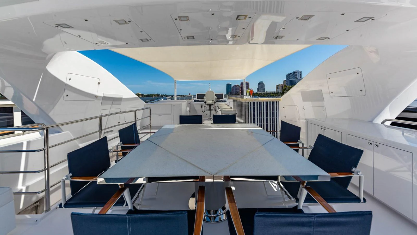 a room with a table and chairs aboard APRICITY Yacht for Sale