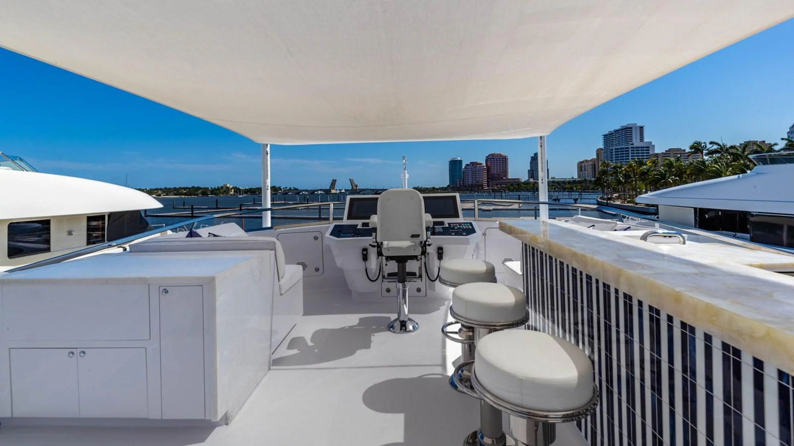 a deck with chairs and tables aboard APRICITY Yacht for Sale