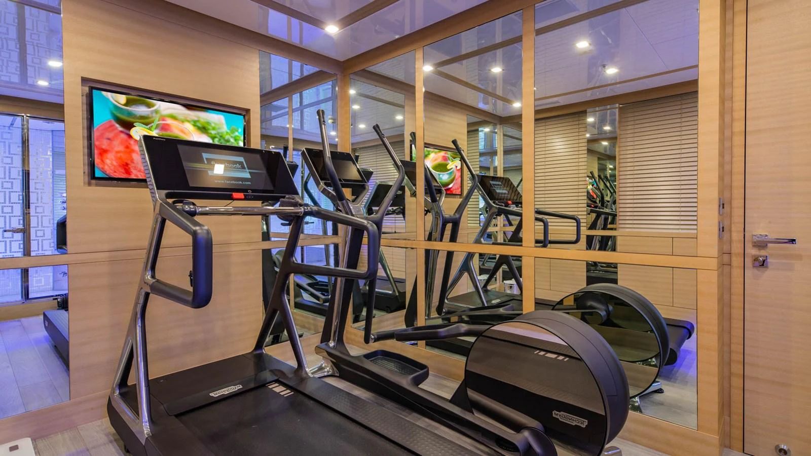 a room with a large window and a tv on the wall aboard APRICITY Yacht for Sale