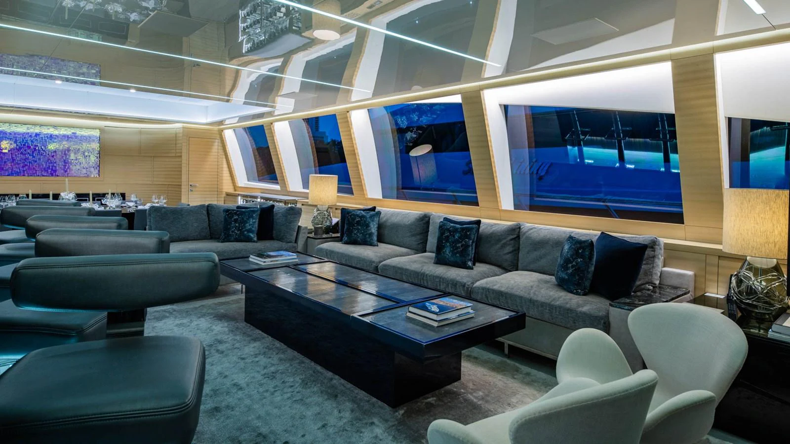 a large living room with a large screen aboard APRICITY Yacht for Sale
