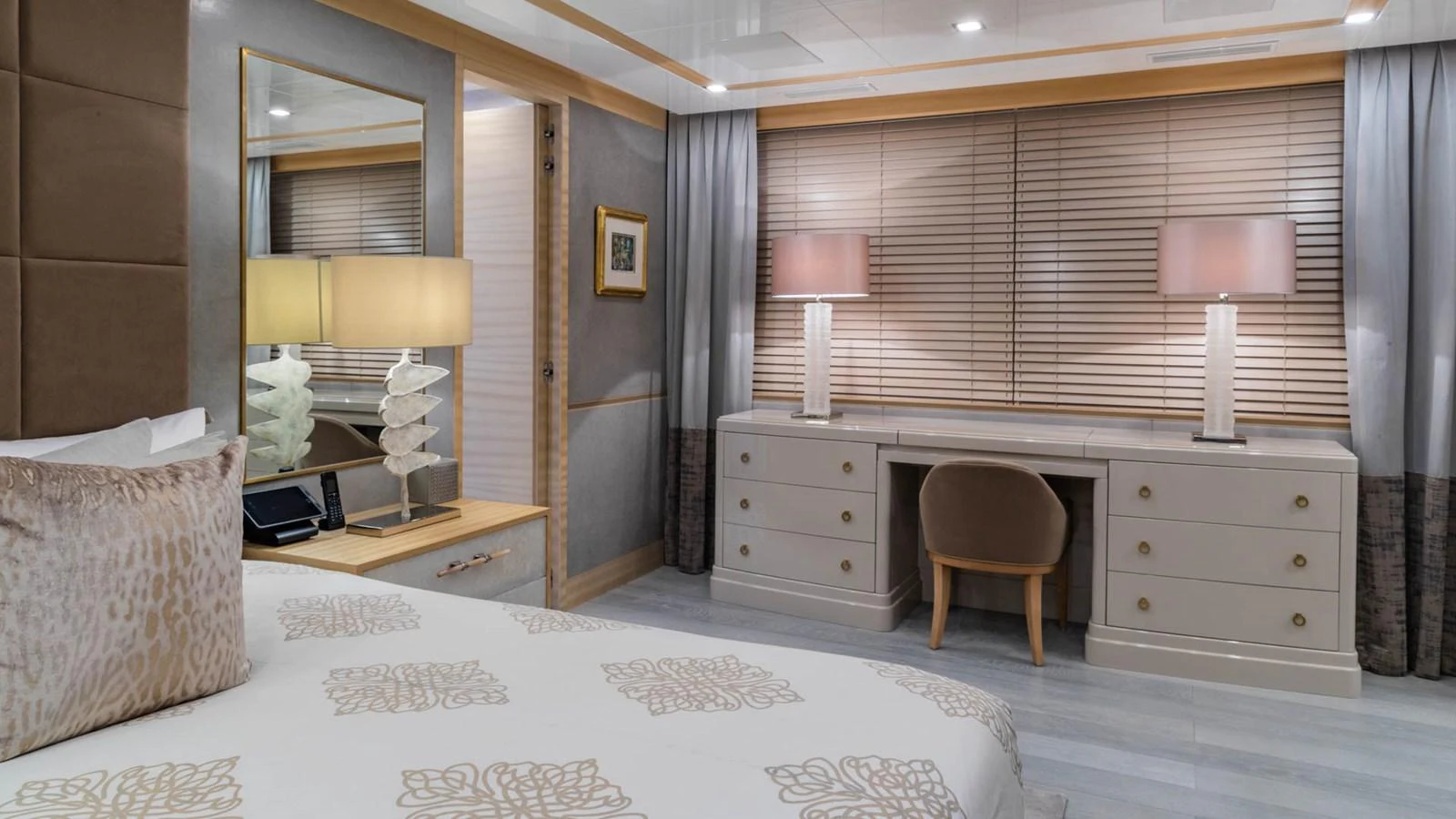 a bedroom with a bed and a desk aboard APRICITY Yacht for Sale