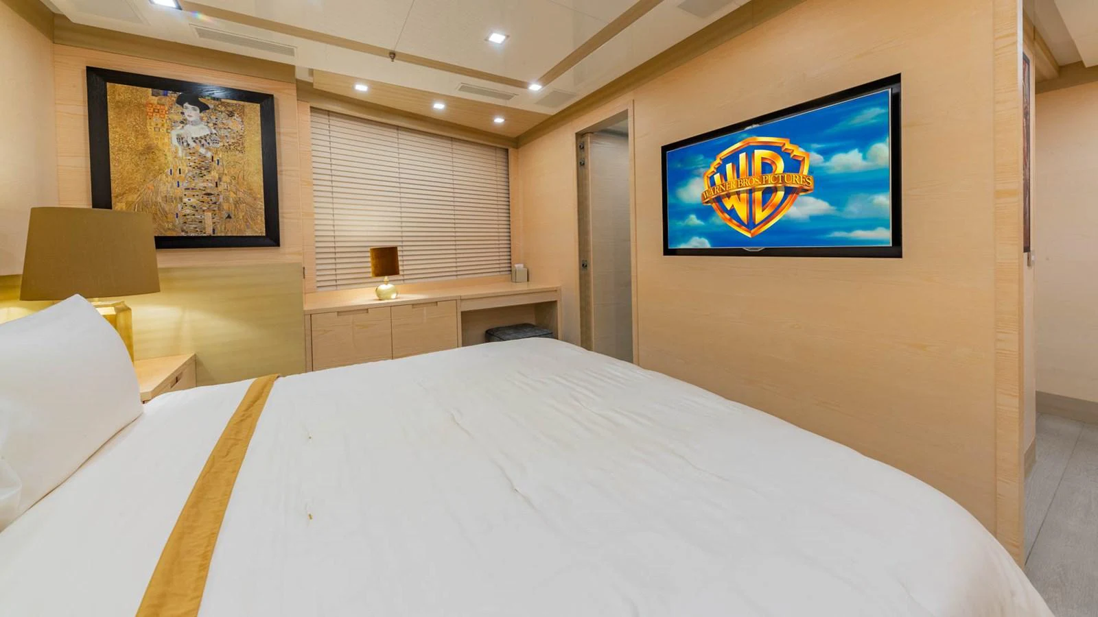 a hotel room with a bed and a tv on the wall aboard APRICITY Yacht for Sale
