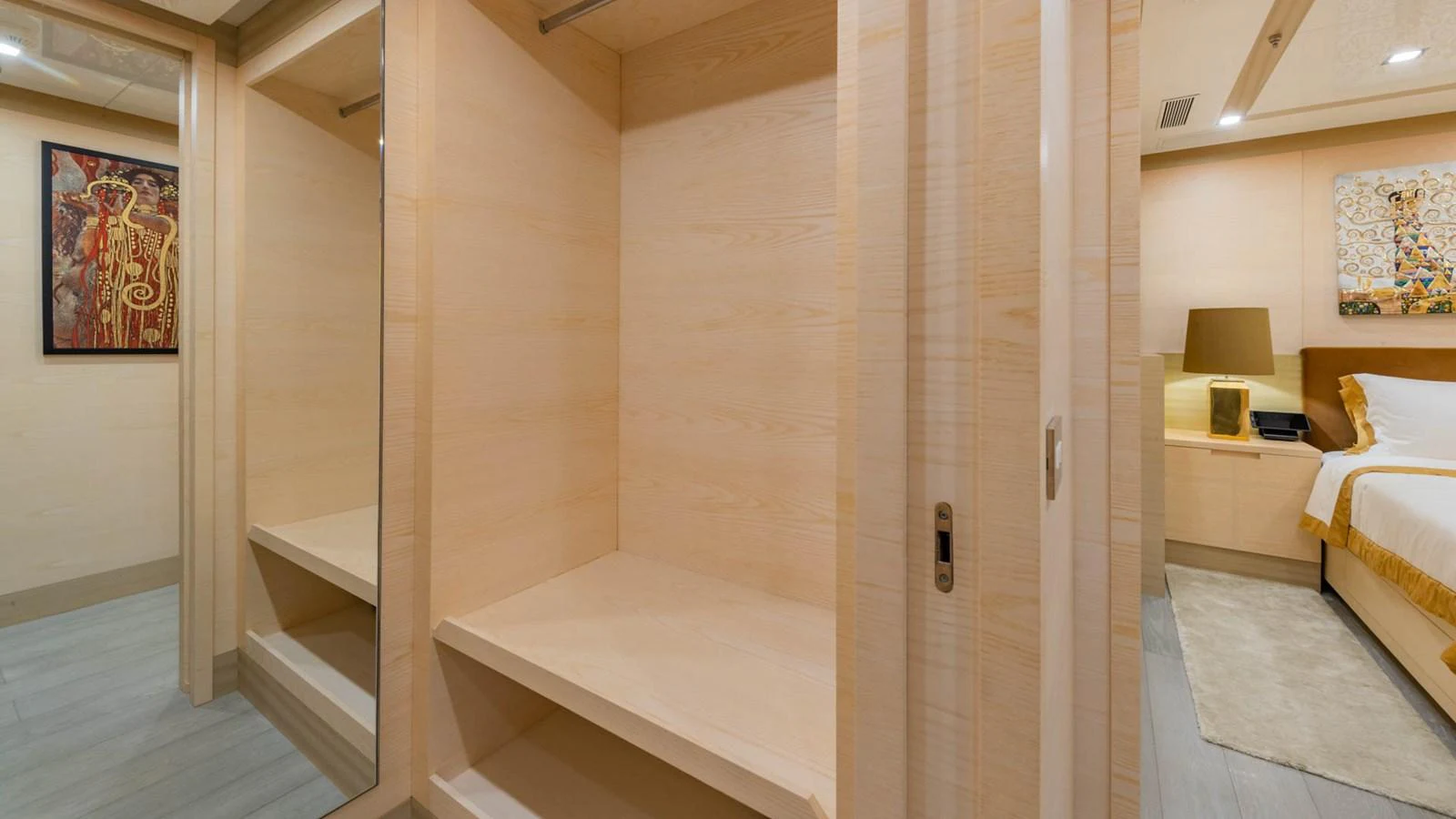 a room with a bed and a lamp aboard APRICITY Yacht for Sale