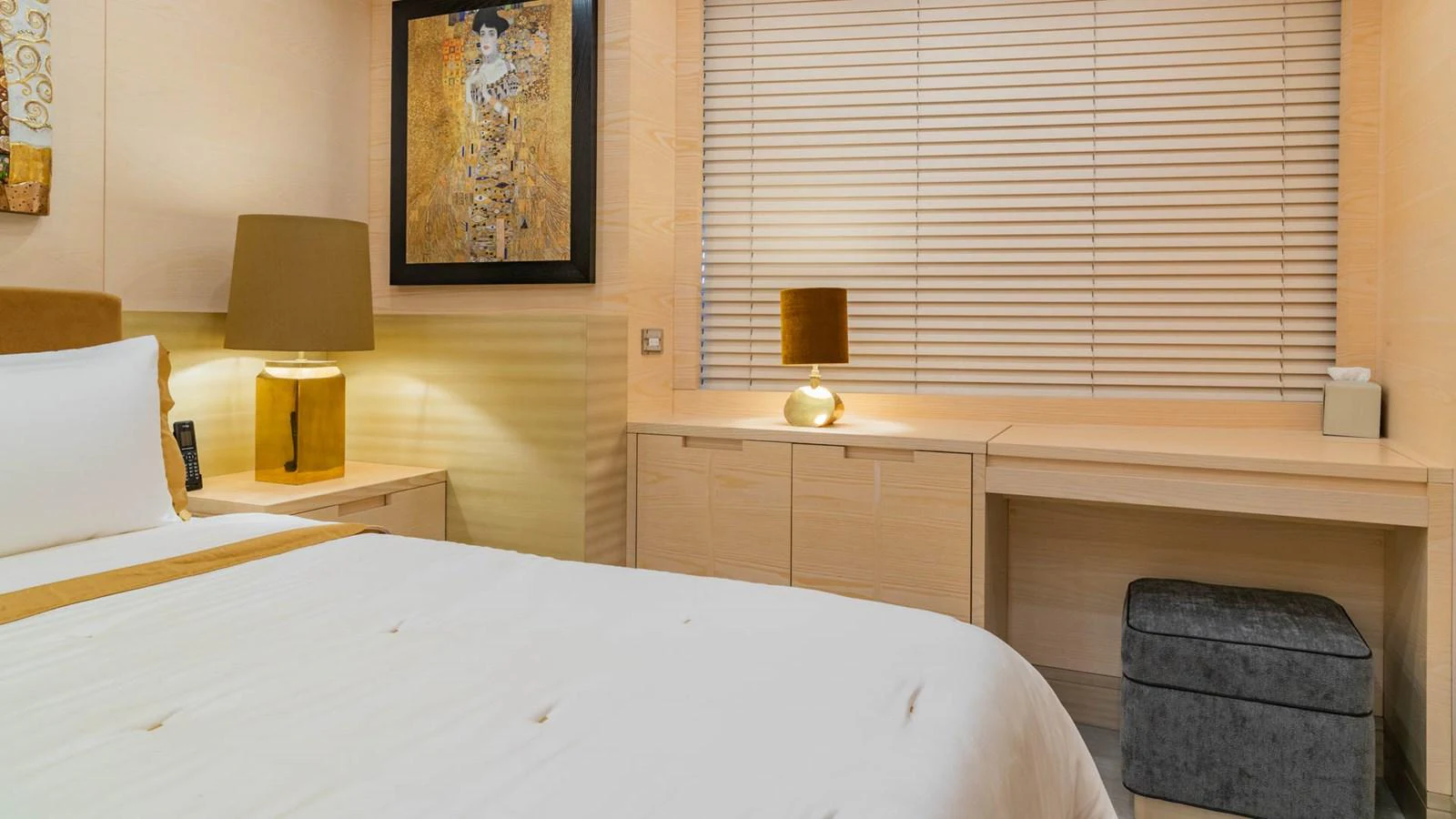 a room with a bed and a lamp aboard APRICITY Yacht for Sale