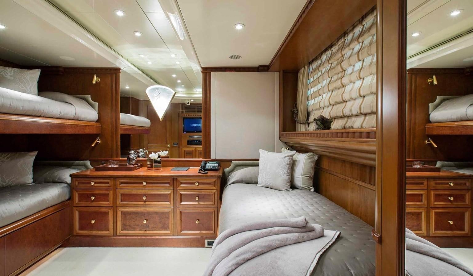 a room with a bed and a dresser aboard COME PRIMA Yacht for Charter