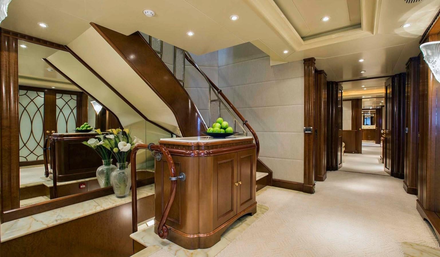 a room with a staircase and vases with flowers aboard COME PRIMA Yacht for Charter