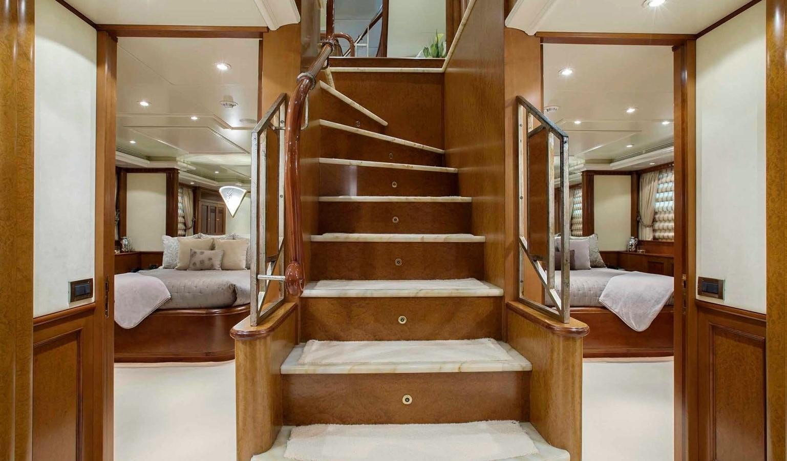 a wooden staircase in a room aboard COME PRIMA Yacht for Charter