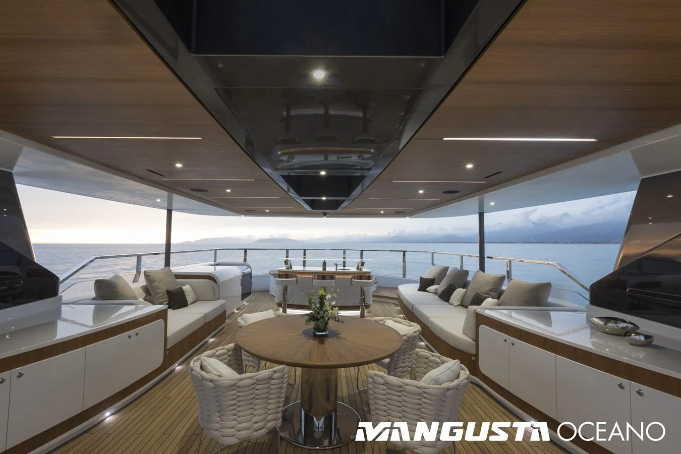 a room with a couch and a table and a large window aboard MANGUSTA OCEANO 50/06 Yacht for Sale