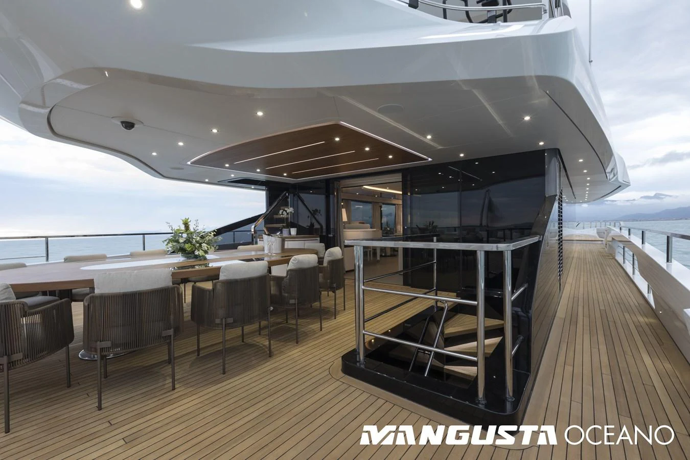 a deck with tables and chairs aboard MANGUSTA OCEANO 50/06 Yacht for Sale