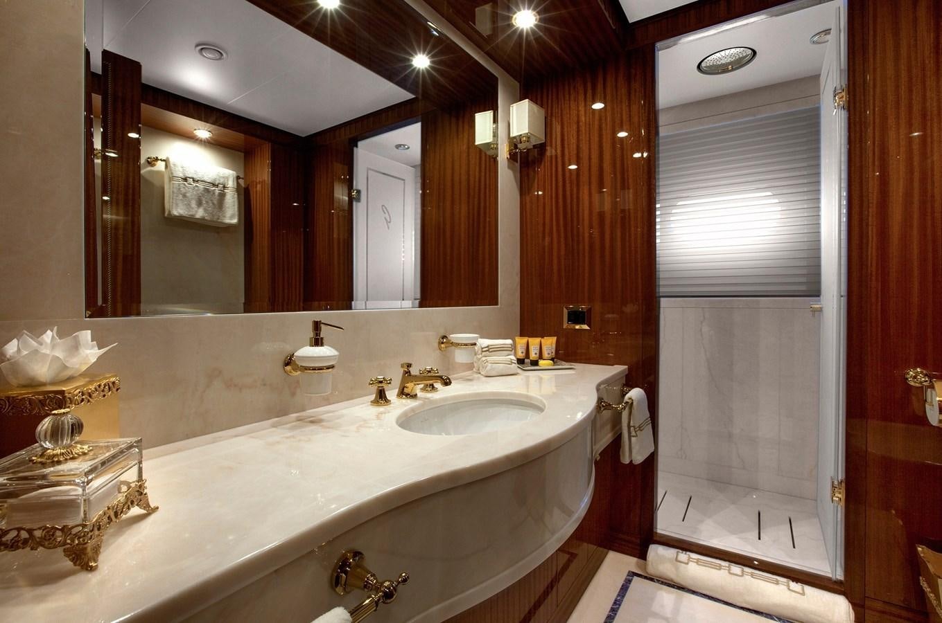 a bathroom with a large mirror aboard KADIMO'S Yacht for Sale