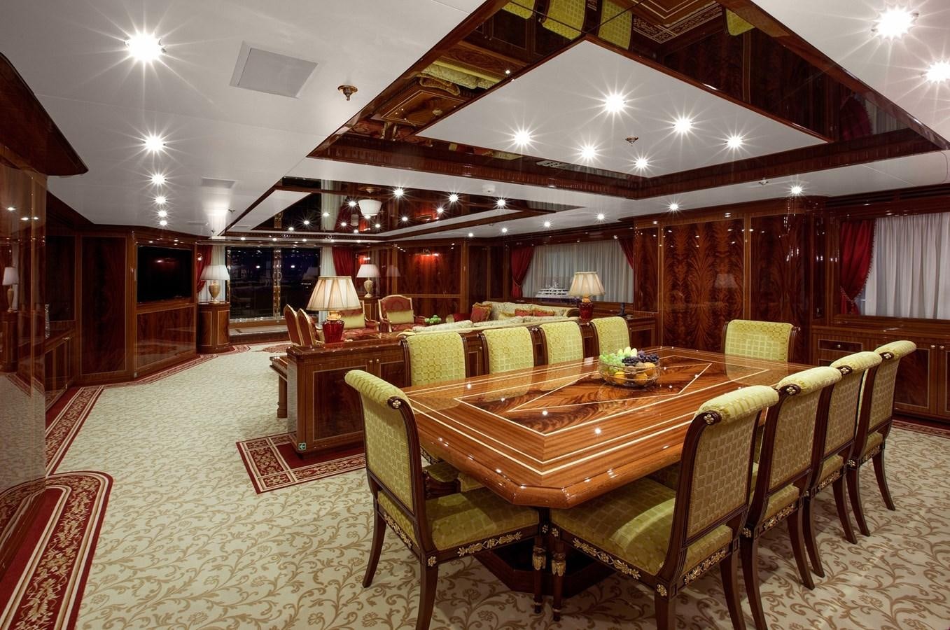 a large room with a table and chairs aboard KADIMO'S Yacht for Sale