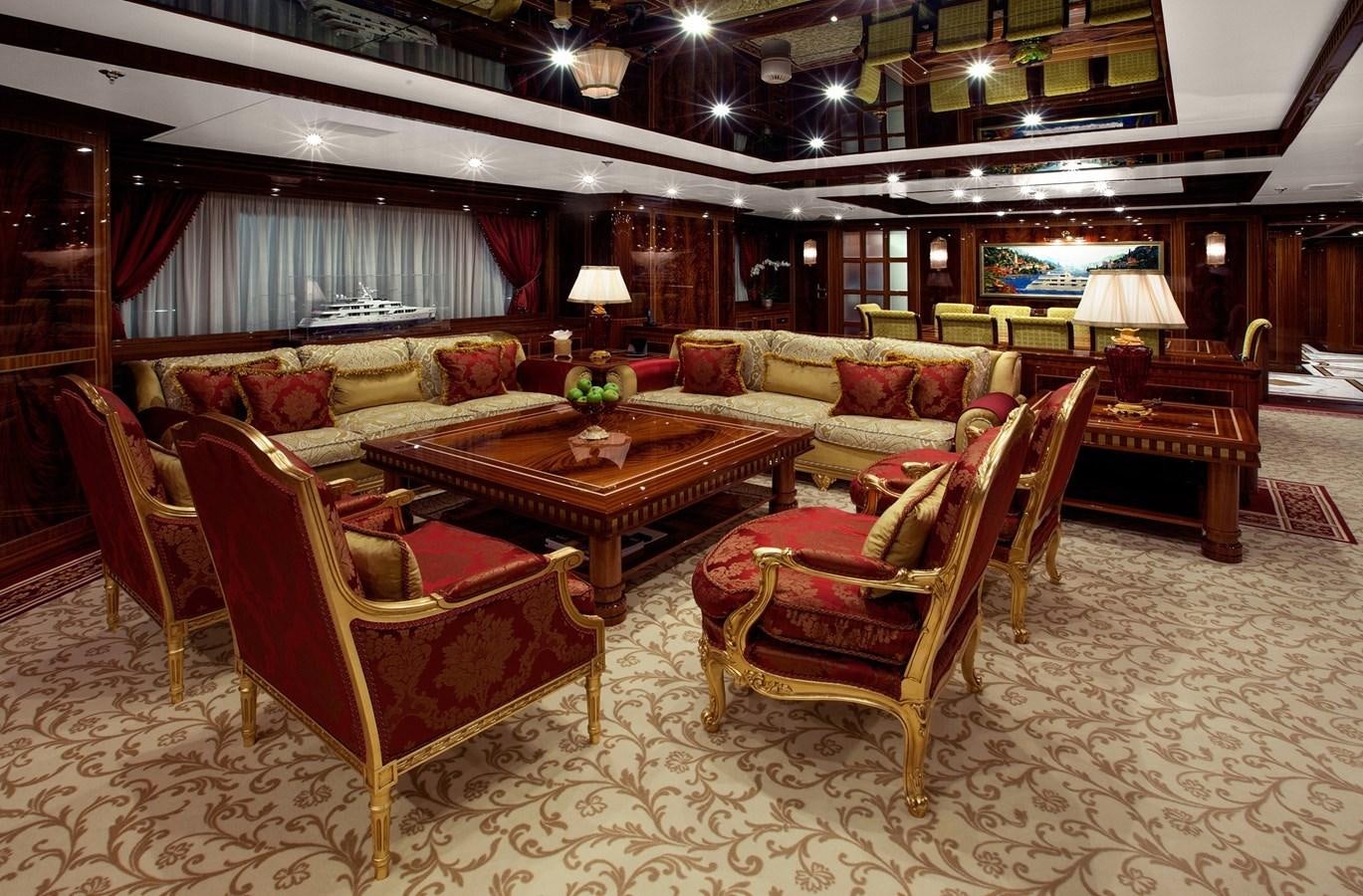 a living room with a couch and a table aboard KADIMO'S Yacht for Sale