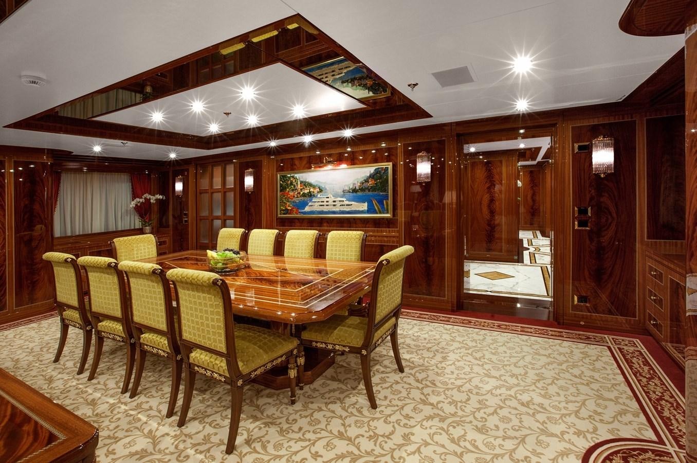 a dining room with a table and chairs aboard KADIMO'S Yacht for Sale