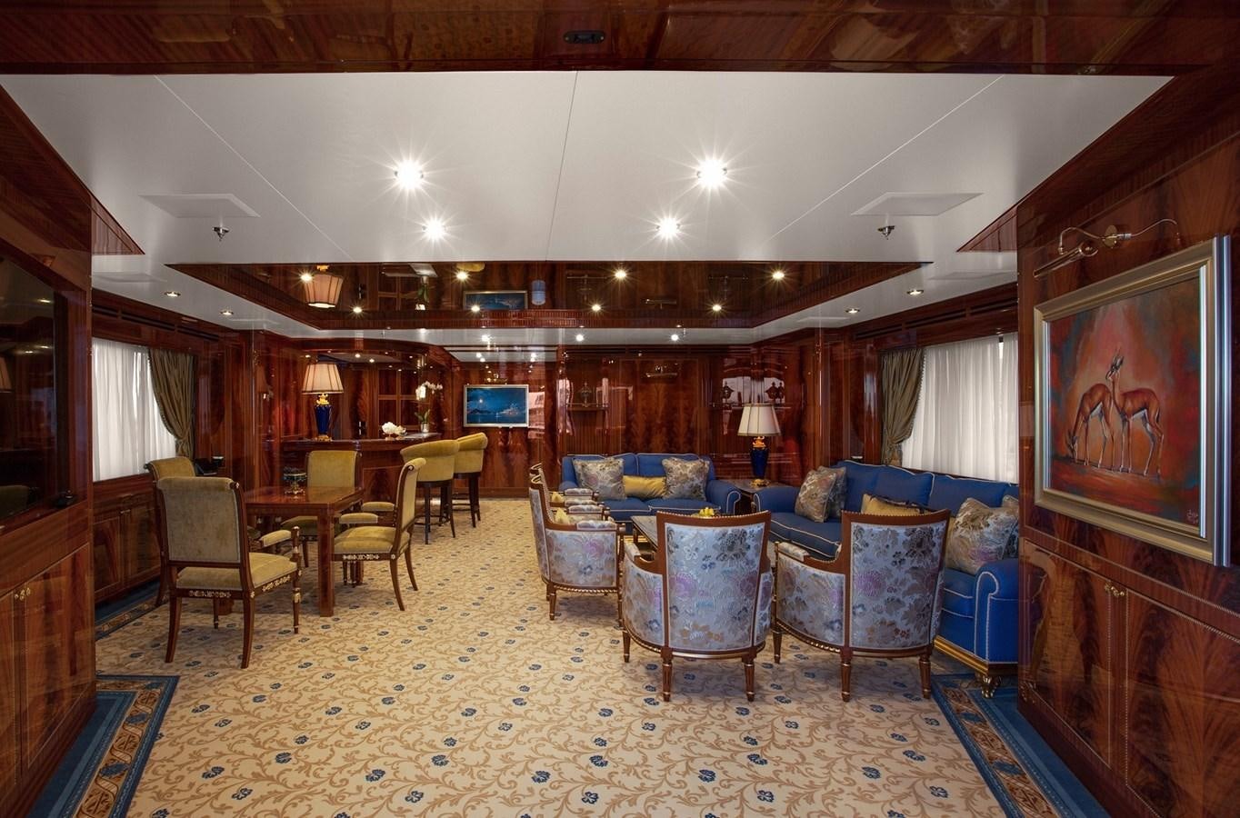 a room with a couch and chairs aboard KADIMO'S Yacht for Sale