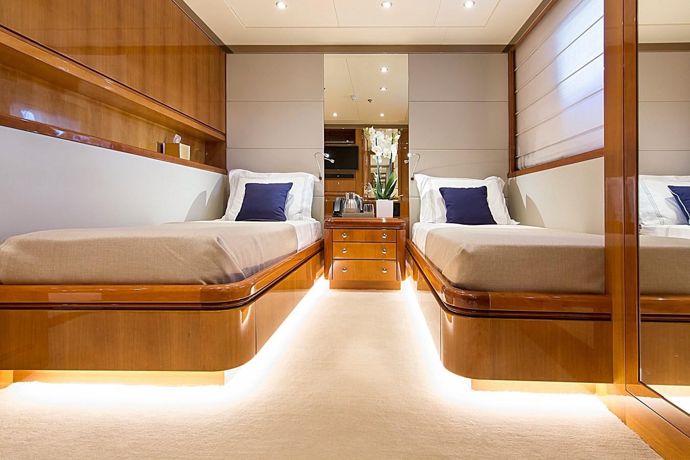a room with a bed and a mirror aboard INVADER Yacht for Sale